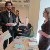 Dr. Dominic Ashby talks with Alyssa Howell while guests mingle.